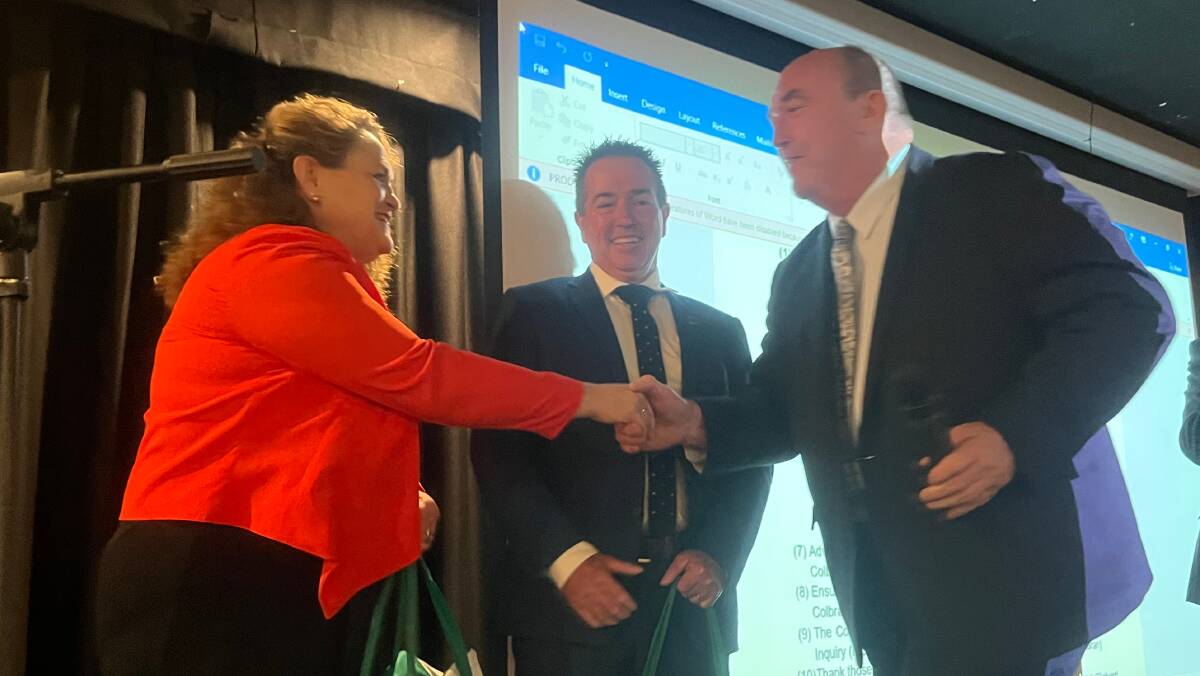 Mayor Russell Fitzpatrick greeting and gifting Bega Valley Shire produce to Minister for Local Government Wendy Tuckerman and Deputy Premier Paul Toole. Photo: supplied