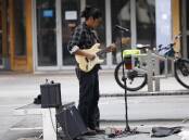 Buskers playing for cash face increasingly lean pickings. Picture by Keegan Carroll