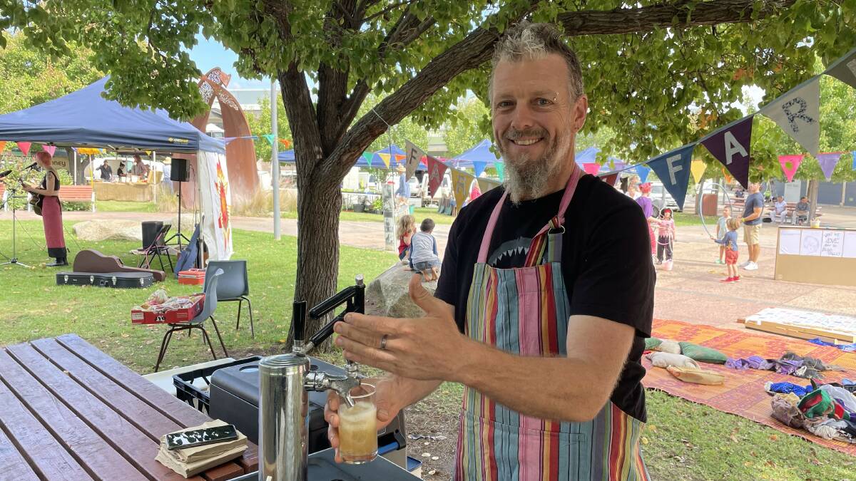 Chris Aitken from Faraway Farm pouring some seasonal homemade kombucha. Picture by James Parker