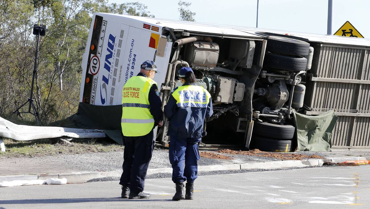 Investigators at the scene of a bus crash near Greta in the NSW Hunter Valley. Picture by AAP Image/Darren Pateman
