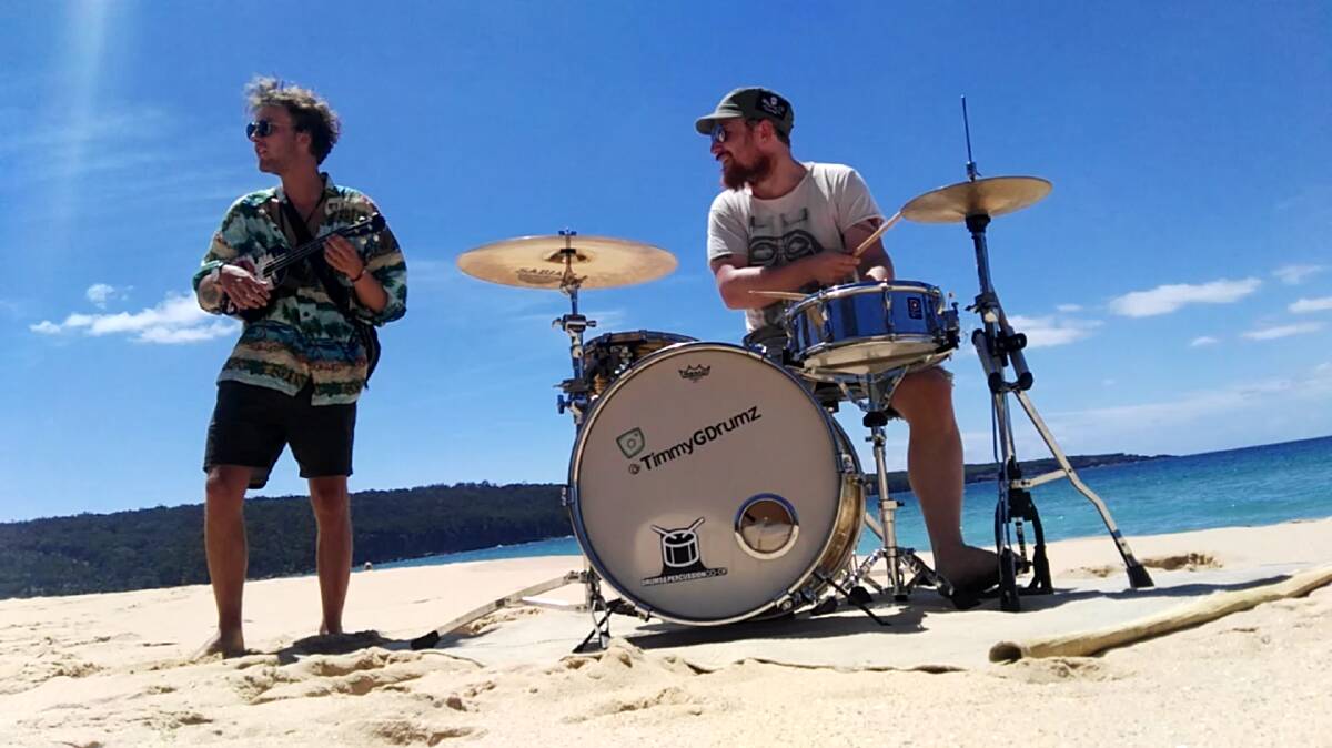Musician and producer Tim Godwin and a Danish backpacker jam on Aslings Beach,  Eden, last weekend.  