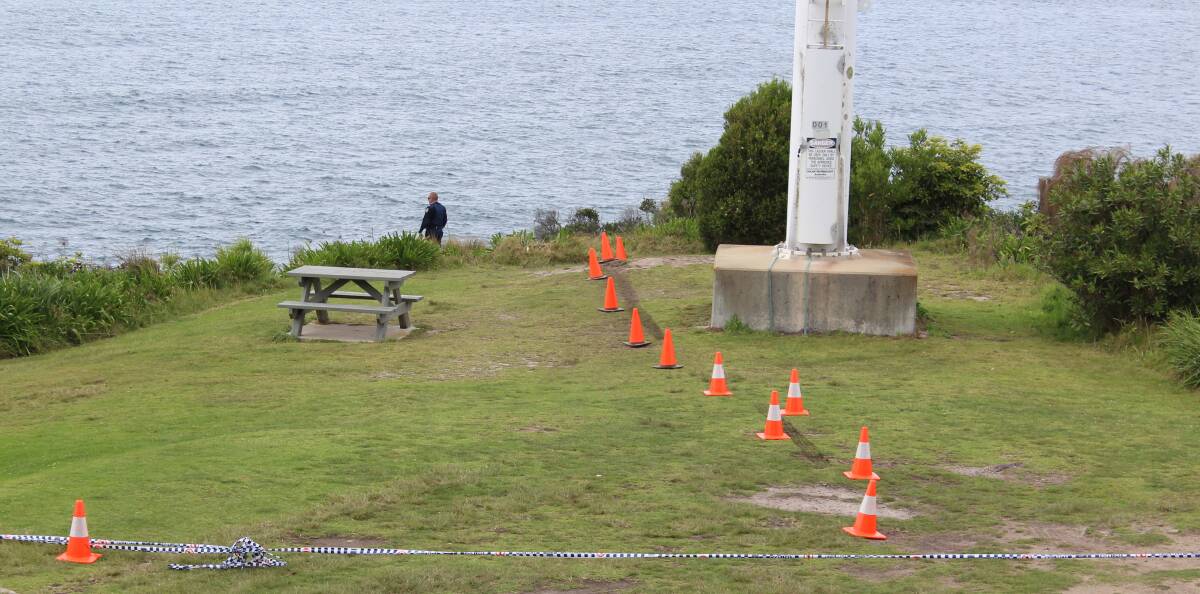 Tragic incident: Police cordon off an area at the top of a cliff in Bramble Street with witches' hats indicating a tyre track heading for the edge.