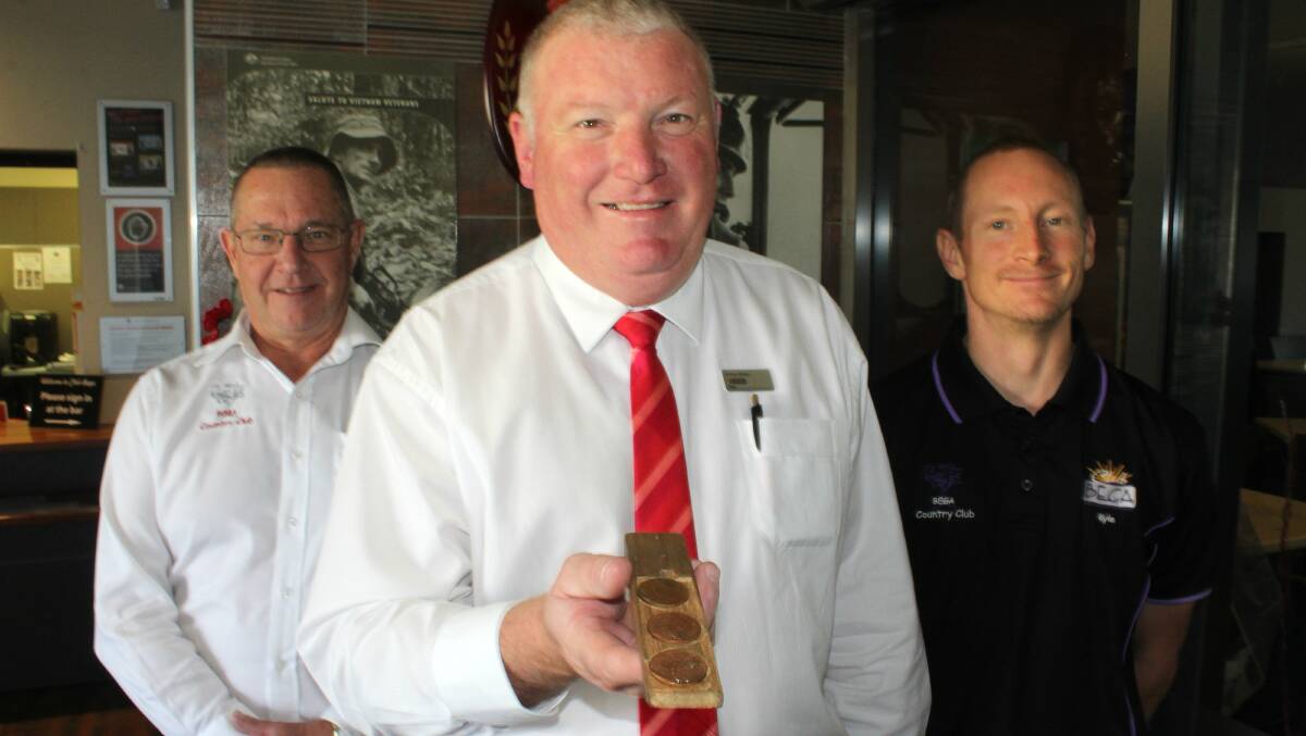 Bega's "boxer" Simon Owens prepares for the annual two-up festivities at Club Bega with club general manager Dave Mitchell and Kyle Bourke.