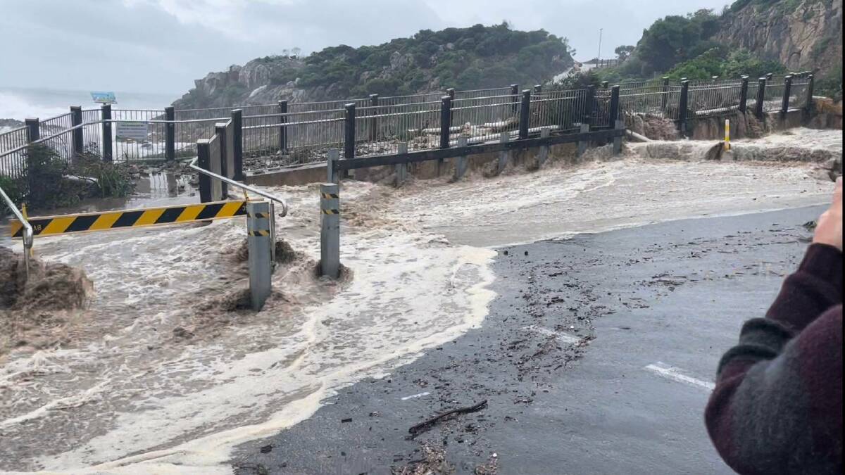 A powerful storm surge hits Tathra Wharf and the headland walkway on April 2, 2023. Picture by Stephen Thelan