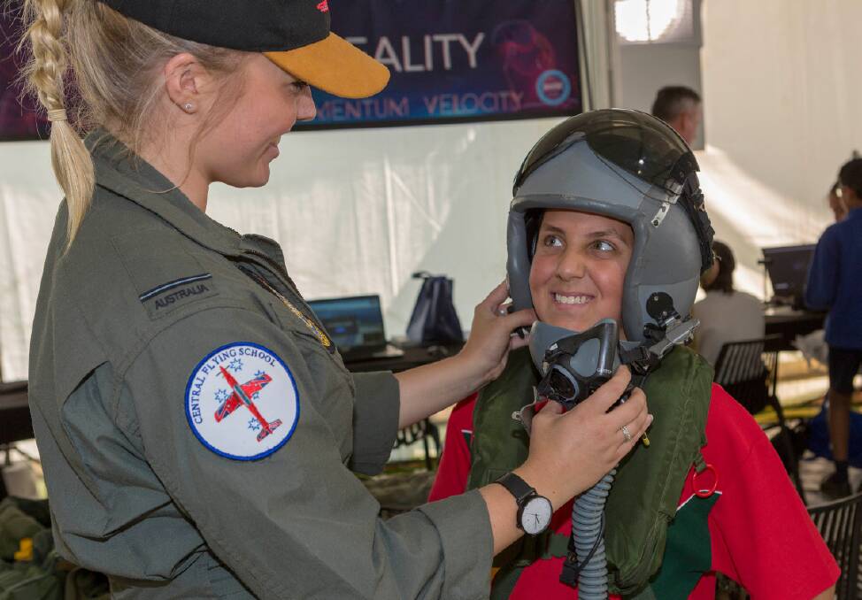 Pilot Officer Isabella Filmer (left) demonstrates some of her equipment