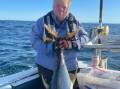 The Tuna Lady of Tura Beach Heather Sutterby, shows off a 30kg yellowfin tuna taken last weekend.