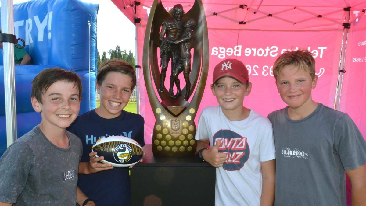 Zade, Kit, Tai and Tom get a close-up look at the Telstra NRL Premiership trophy, which was on display as part of the weekend's 'Festival of Football' in Bega. Photo: Ben Smyth