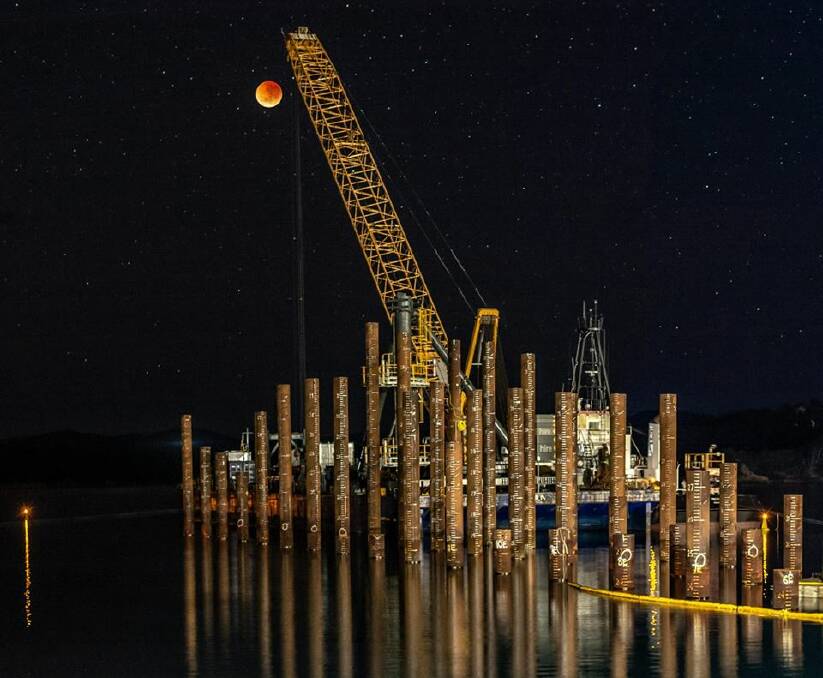 Garry Hunter had a brilliant eye for composition when he rose early for Saturday's lunar eclipse. Here's the Eden wharf crane lowering the moon on Snug Cove.