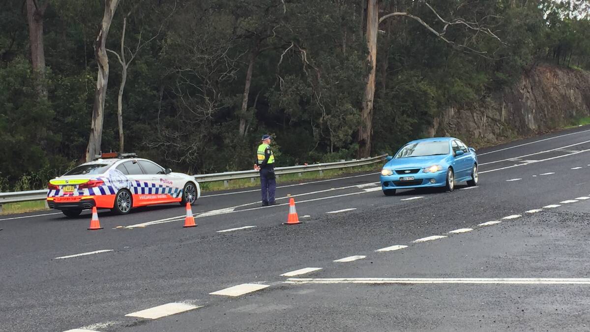 Police direct traffic on to Nethercote Rd after a car crash on the Princes Hwy near Broadwater. Photo: Denise Dion