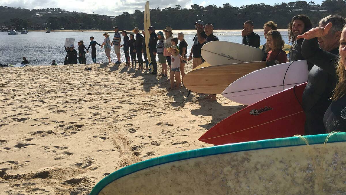 Paddlers gather in support of a campaign calling on council to consider alternatives to pumping treated effluent into the ocean off Merimbula. Photos supplied