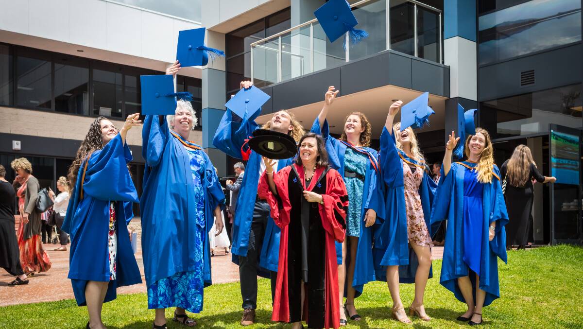 University of Wollongong Bega campus graduates celebrate at last Friday's ceremony. Photo: Kit Goldsworthy