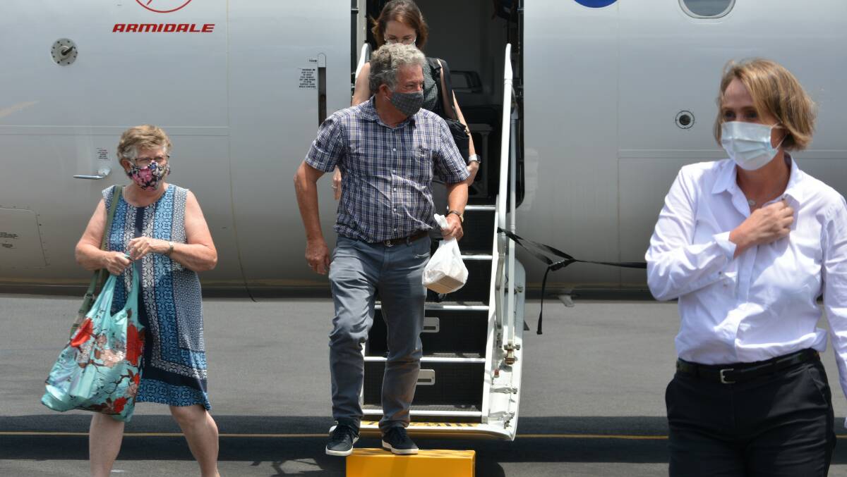 Former Merimbula Airport manager Ian Baker and wife Cathy disembark the inaugural Qantas flight. Photo: Ben Smyth