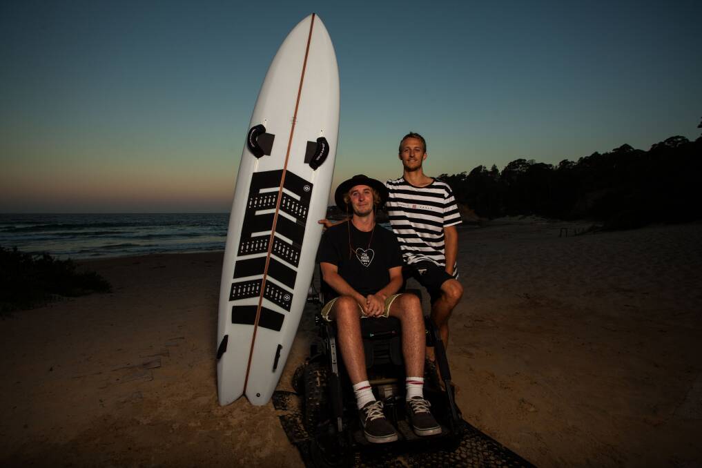 New board: Jason Apps pictured with his brother and carer Will Apps at Tathra Beach. Picture: Rachel Mounsey.