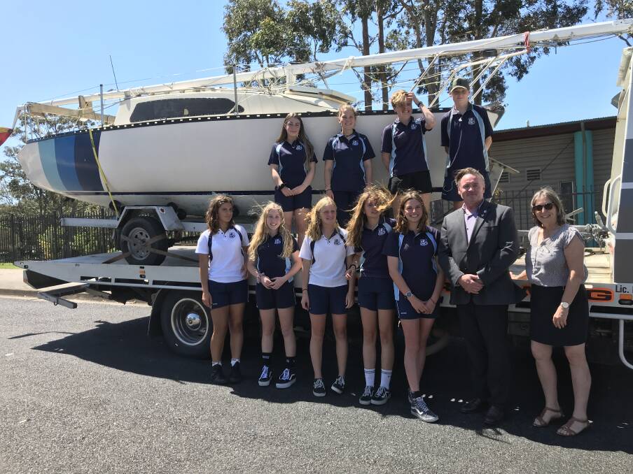 Special delivery: Eden Marine High students check out the 22-foot yacht surprise gift from Dalmeny woman Donna Anderson, delivered on Friday. Picture: Supplied. 