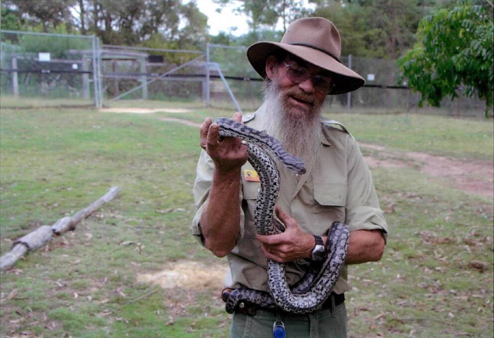 Snake mate: Phillip Sproates, aka Sprocket the snake handler from Potoroo Palace with one of the pythons. 