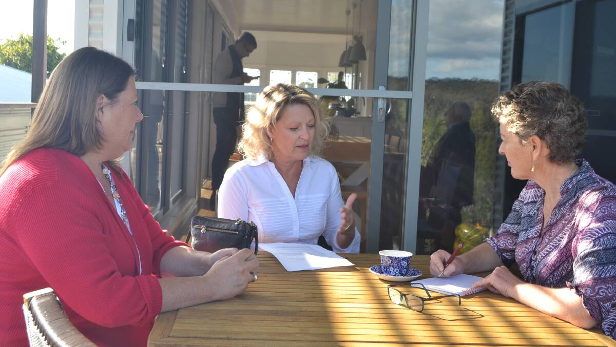 Fiona Kotvojs (right) takes down notes when speaking with business people of Narooma. 
