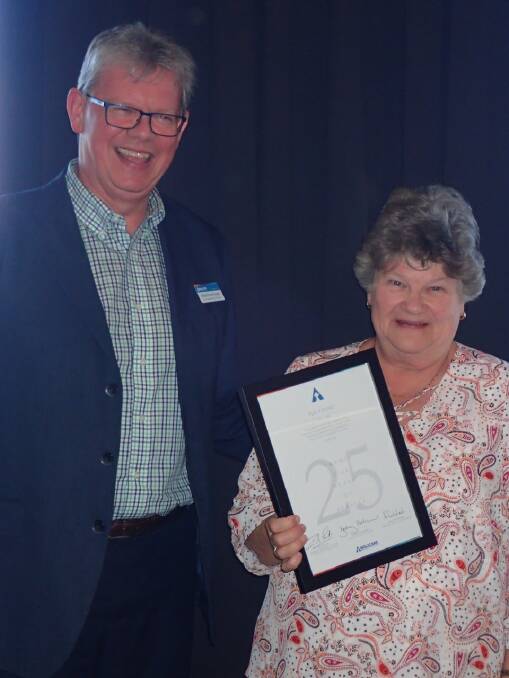 Reverend Doctor Ian Coutts presenting Flo Young an award for her 25 years of voluntary service in the community. 