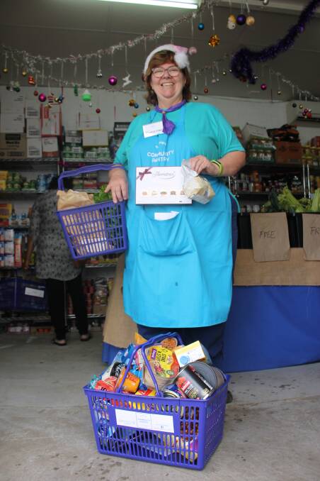 THE MORE THE MERRIER: Christine Welsh believes everyone deserves a feast this Christmas. These baskets hold groceries to feed a family from Christmas to New Years that only cost $44 from the Sapphire Community Pantry.