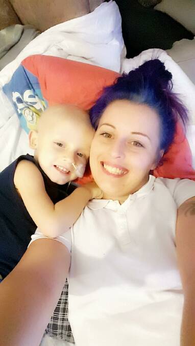 STILL SMILING: Joshua and his mum Hannah Cody take a moment to pose for the camera during Joshua's cancer treatment. 