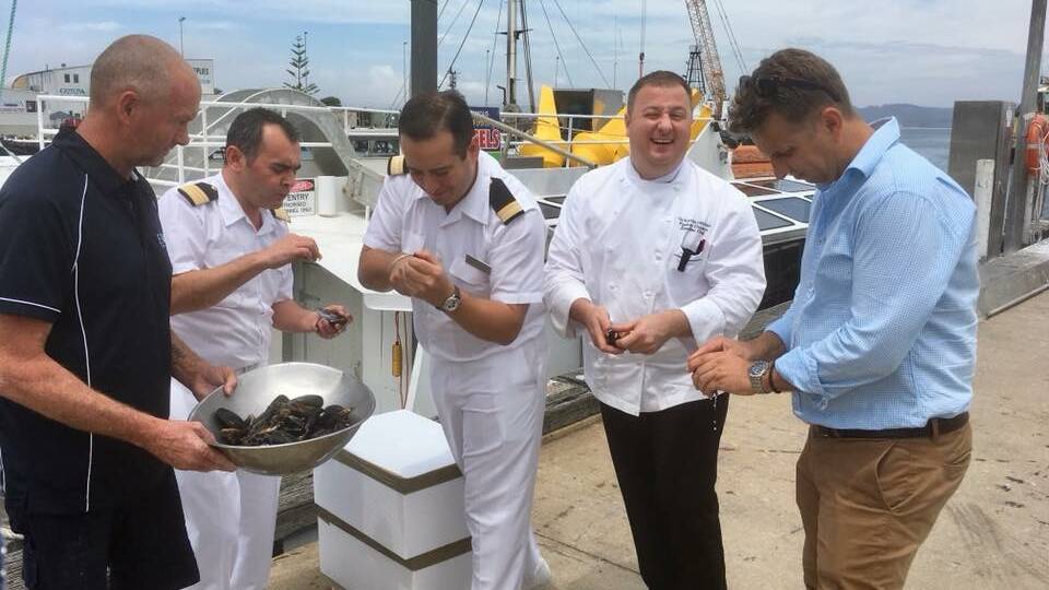 The head chef and crew members of the Oceania Regatta share mussels and a laugh with Bega MP Andrew Constance.