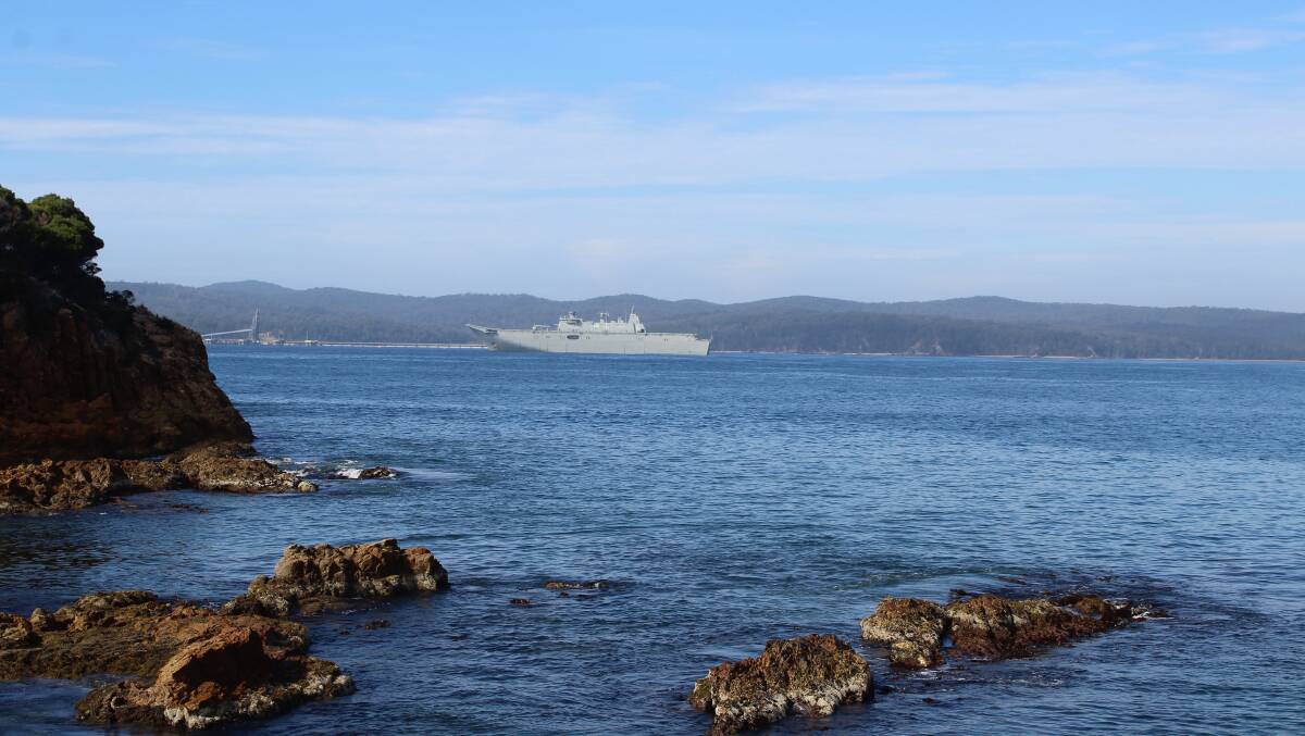 VIEW FROM SHELLY'S BEACH: The HMAS Adelaide glides into Twofold Bay.