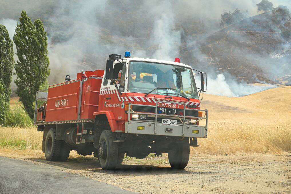 BATTLING ISSUES: RFS firefighters on River Road in Jingellic during the summer bushfires.