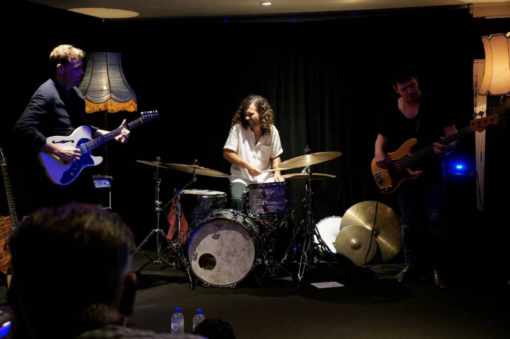 TIGHT: Adam Miller, left, on stage with Dom Borzestowski and Mitch Cairns, right, at the Grand Hotel's Underground in 2018. Picture: Paul Dear 
