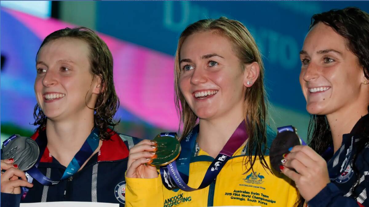 Australian gold medallist Ariarne Titmus, centre, stands with silver medallist United States' Katie Ledecky and her compatriot and bronze medallist Leah Smith after the 400m freestyle final.