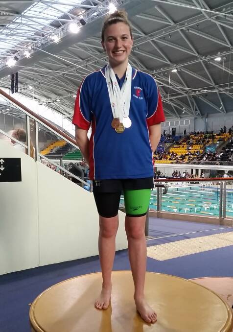 Gold, silver and bronze: Georgia Caldwell is all smiles on the podium at the NSW State Age Short Course Championships in Sydney last weekend. Picture: Melina Caldwell