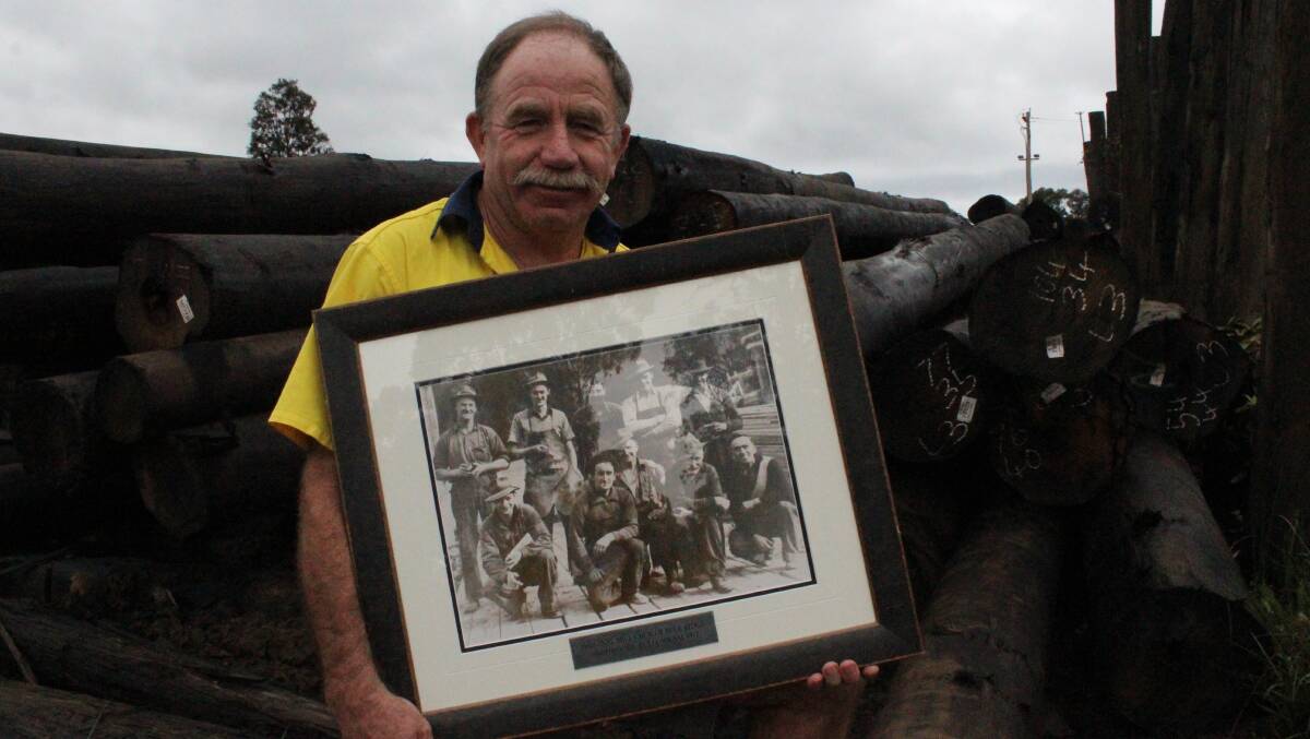 IN THE BLOOD: Managing director of Blue Ridge Hardwoods Eden, Allan Richards, stands in his mill with a 1948 photo of his father and logging team in his hands. Picture: Toni Houston