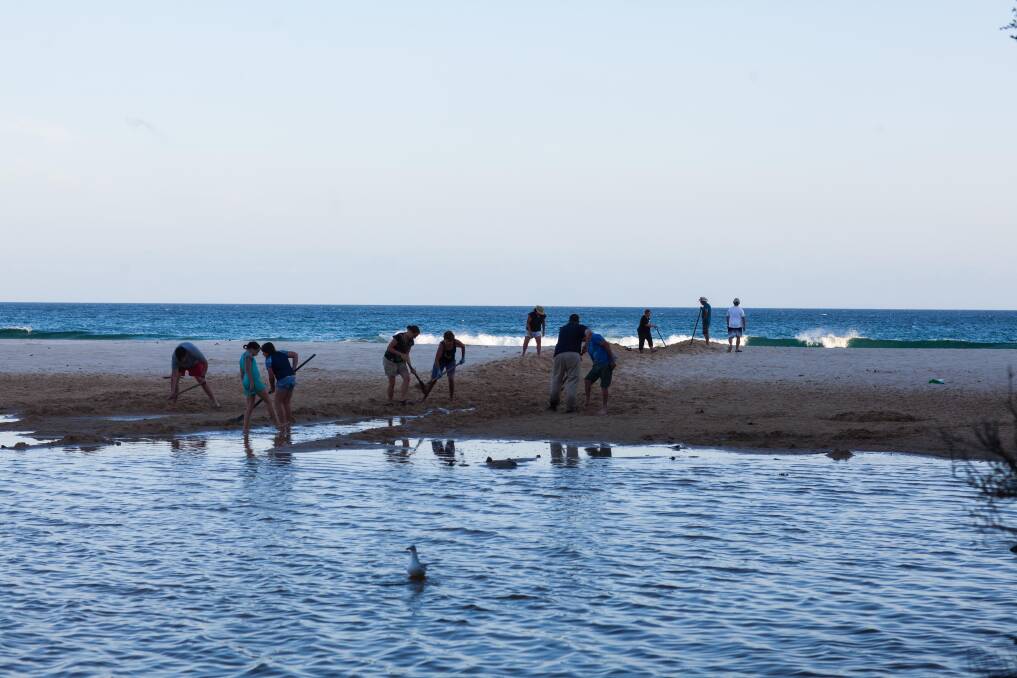  "Now is not the time." A group of locals fill in a tourist made trench at Betka beach. Photo Rachel Mounsey