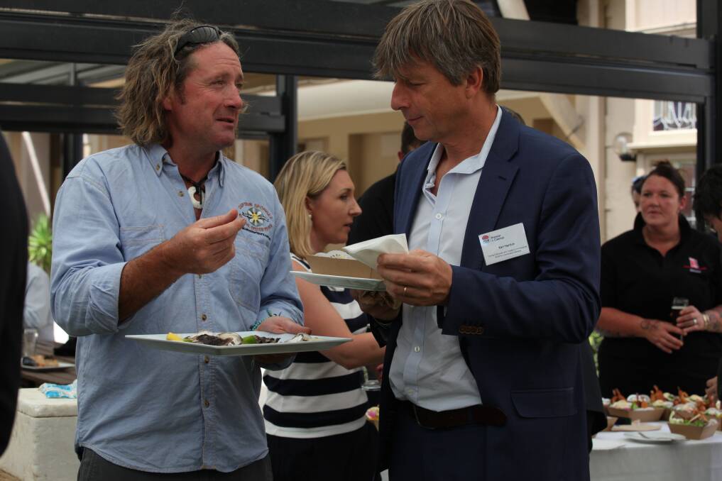 Brett Weingarth from Captain Sponge's Magical Oyster Tours talks oysters with Austrian Consul General Karl Hartleb. Picture: Rachel Mounsey