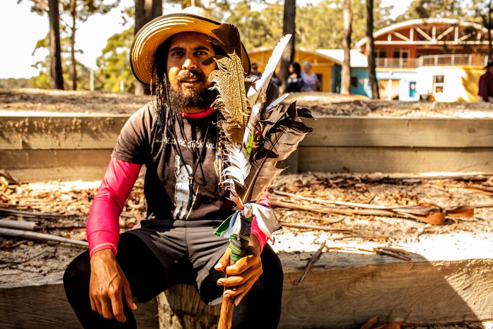 Alwyn Doolan holds the First Nations message stick during a welcoming smoking ceremony at Twofold Aboriginal Corporation. 