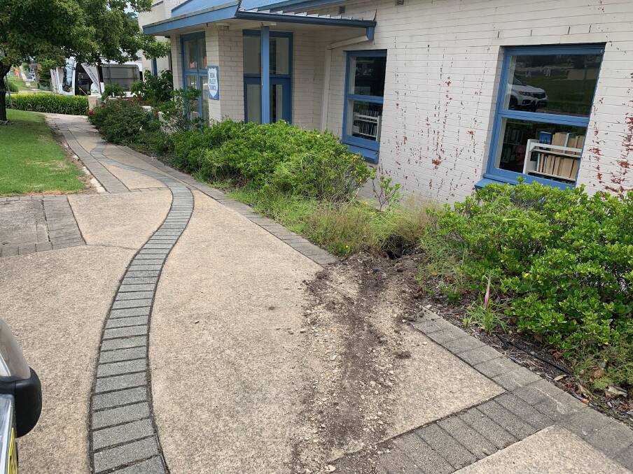 Something missing: The Welcome to Refugees and Asylum Seekers sign has been stolen from outside of the Eden Library. The tyre marks are the trail the thieves left behind. 