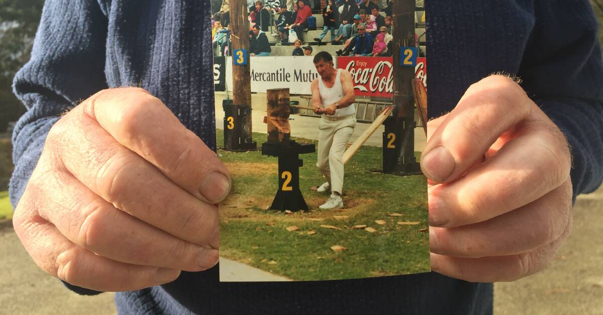 WEATHERED HANDS: Kiah axeman Bob Munday holds up a photo of his younger self participating in one of the many Easter tournaments at the Sydney Royal Show. Picture: Rachel Mounsey