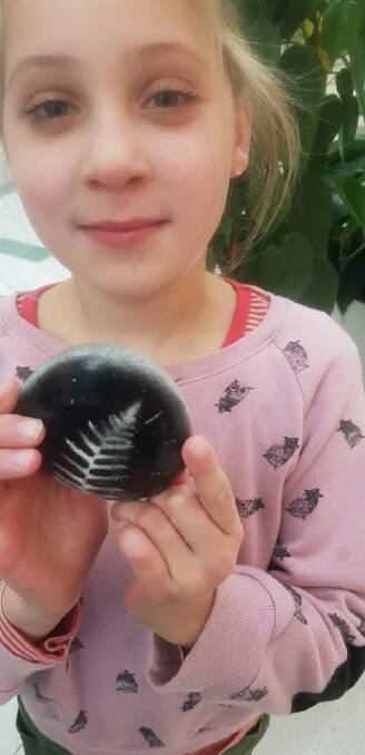 A Good Omen: Eden Burton from Christchurch New Zealand holds the rock she organised to be delivered to Eden Public School. Photo used with permission by Lorelle Burton
