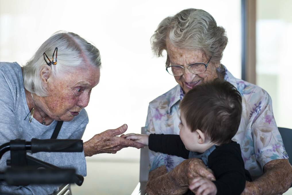 Residents at Albert Moore Gardens enjoying the company of 8-month-old Jesse during the playtime session aimed at connecting elderly and young children. Photo: Rachel Mounsey