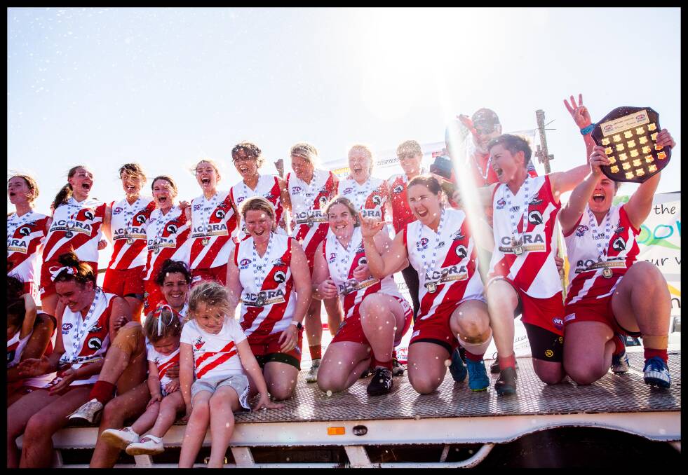  AFL Sapphire Coast Womens League Grand Final Winners, The Eden Whalers under a shower of champagne moments after winning the cup . Picture: Rachel Mounsey