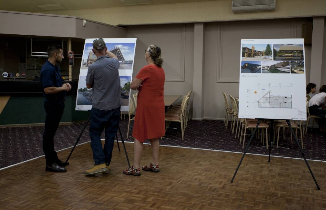 Community members talk through the Eden Welcome Centre designs with a Port Authority NSW team member. 