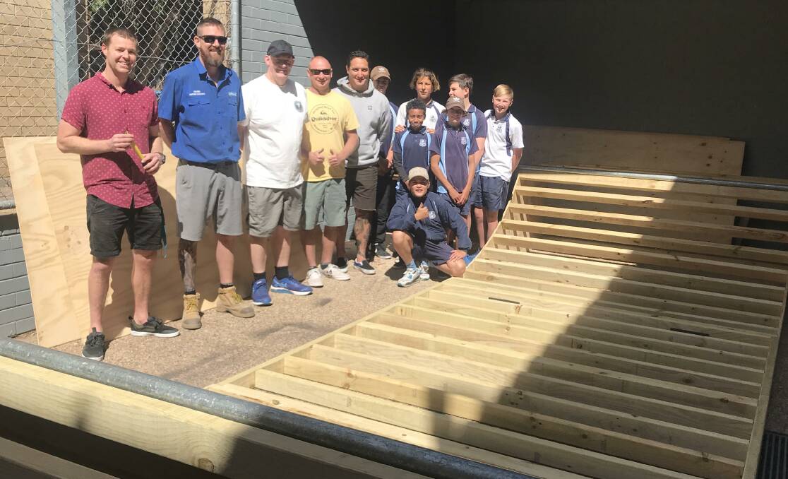 Almost ready to go: Eden Marine High students, sponsors of the ramp Eden Mitre 10 and Raging Bull Surf along with committee members of the Sapphire Coast Skate Park Association with the ramp at the school. Photo: Supplied. 