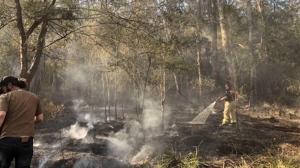Fire services attend to a fire on Brandy Creek Road on the Nullica River, south of Eden on Saturday. Photo: NSW Fire and Rescue Eden 