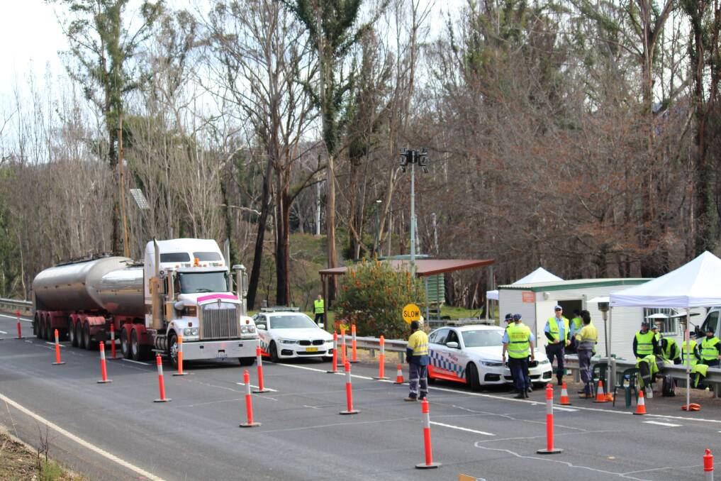 POLICE AT WORK: A picture of the operation at the Princes Hwy NSW-Victoria border closure checkpoint at Timbillica, taken last Friday. Picture: Leah Szanto