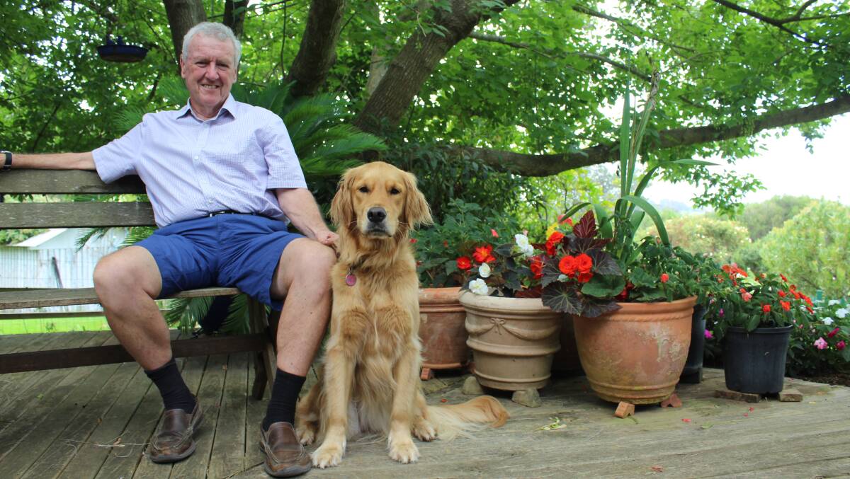 WELL-EARNED APPOINTMENT: Bruce Leaver takes a break in his garden at Coolagolite with his dog Remy.  