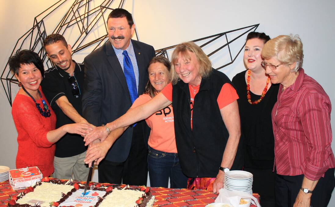 PAST CELEBRATIONS: Cutting the cake at the launch of SPAN's mental health month calendar in 2015 are SPAN members Jen Keioskie, Ben Thomas, Labor's Mike Kelly, Tracey Escreet, Liz Seckold, Beck Minear and Helen Best. 