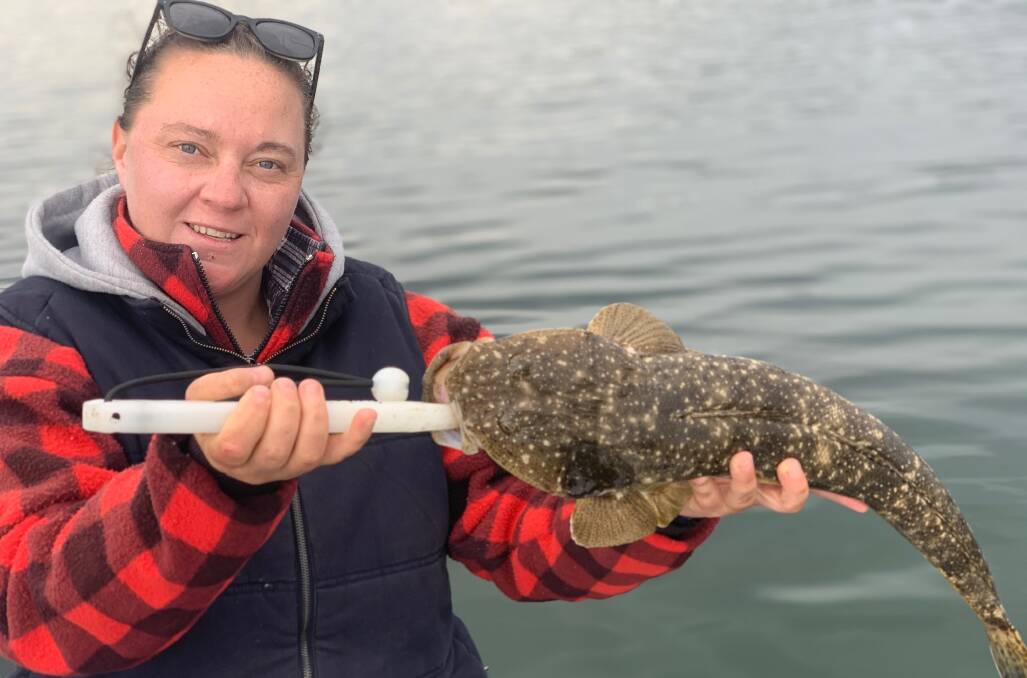 MBGLAC member Giddy Brandauer holds a lovely catch and release dusky flathead at Merimbula Lake.