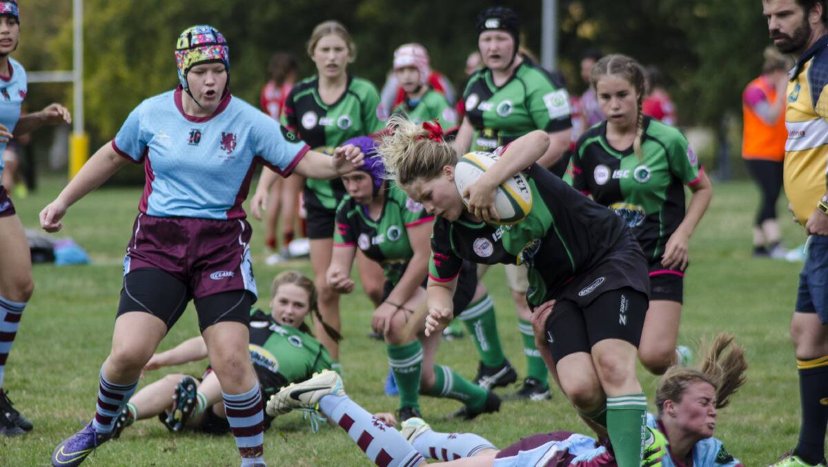 Hard runner: Rhianna Burke crashes through a tackle as part of the Falcons' combined squad with Jindabyne last week. 