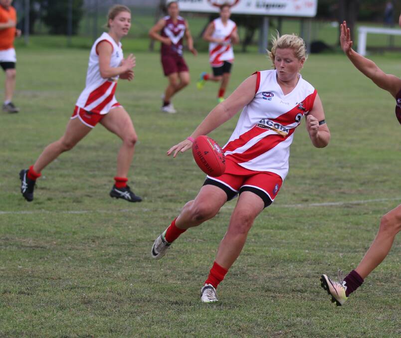 In control: Kate Mitchell gets a kick away during Eden's win over Tathra in round one with the Whalers backing up against Bermagui on Saturday. 