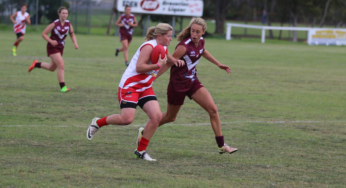 Mel Mitchell goes toe-to-toe with Tathra's Tarni Evans in a clash last season, while Saturday's game was cut short in the second quarter. 