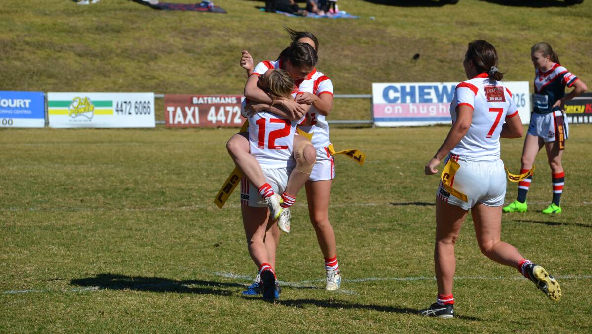 Sweet result: Eden Tigerettes players embrace after a come-from-behind victory over the Bega Chicks to secure a grand final berth. Picture: Joel Erickson. 