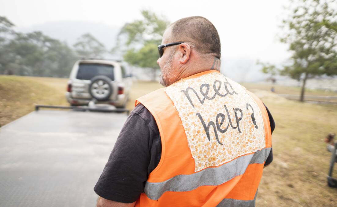 A volunteer helps following the Black Summer bushfires. A disaster preparedness group in Eden is surging ahead. Picture: Dion Georgopoulos 